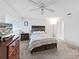 Comfortable bedroom with TV and ceiling fan at 13804 Mill Cove Cir, Tampa, FL 33618