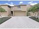 Townhouse exterior featuring a garage, landscaping and a brick driveway at 13804 Mill Cove Cir, Tampa, FL 33618