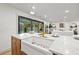 Kitchen features a farmhouse sink, marble countertops, and a view of the pool at 1400 Farragut Dr, St Petersburg, FL 33710