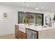 Kitchen island with farmhouse sink, gold faucet, and marble countertop at 1400 Farragut Dr, St Petersburg, FL 33710