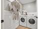 Bright laundry room with washer, dryer, and stylish wallcovering at 1400 Farragut Dr, St Petersburg, FL 33710