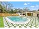 Enjoy this refreshing oval pool with surrounding patio and lush landscaping at 1400 Farragut Dr, St Petersburg, FL 33710