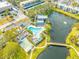 Aerial view of community pool, shuffleboard, and pond at 14130 Rosemary Ln # 2203, Largo, FL 33774