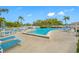 Community pool area with lounge chairs and tables at 14130 Rosemary Ln # 2203, Largo, FL 33774