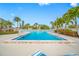 Community pool with surrounding lounge chairs at 14130 Rosemary Ln # 2203, Largo, FL 33774