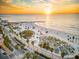 Beachfront aerial view at sunset, showing beachgoers and palm trees at 1415 Ridge Ave, Clearwater, FL 33755