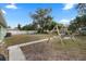 Fenced-in backyard with swing set and patio area at 1415 Ridge Ave, Clearwater, FL 33755