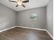 Simple bedroom with ceiling fan and wood-look flooring at 1415 Ridge Ave, Clearwater, FL 33755