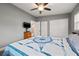 Bright bedroom with ceiling fan, large closet, and wood-look flooring at 1415 Ridge Ave, Clearwater, FL 33755