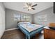 Well-lit bedroom with hardwood floors, ceiling fan, and ample closet space at 1415 Ridge Ave, Clearwater, FL 33755