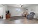 Relaxing living room featuring hardwood floors, a ceiling fan, and comfortable armchairs at 1415 Ridge Ave, Clearwater, FL 33755