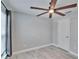 Bedroom with gray walls, ceiling fan, and a white door at 14525 Scottburgh Glen Dr, Wimauma, FL 33598