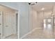 Clean hallway with tile floors, and doors leading to other rooms at 14525 Scottburgh Glen Dr, Wimauma, FL 33598