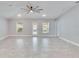 Spacious living room with tile floors and access to the backyard at 14525 Scottburgh Glen Dr, Wimauma, FL 33598