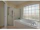 Bathroom with soaking tub and glass block window at 16809 Woburn Ln, Lutz, FL 33549