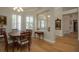 Bright dining room with hardwood floors and view to entryway at 16809 Woburn Ln, Lutz, FL 33549