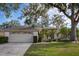 Single-story house with attached garage and large yard at 16809 Woburn Ln, Lutz, FL 33549