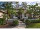 Inviting home exterior featuring a landscaped walkway and lush greenery at 16809 Woburn Ln, Lutz, FL 33549