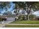 Single-story house with attached garage and well-kept lawn at 16809 Woburn Ln, Lutz, FL 33549