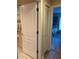 Short hallway with linen closet and bedroom access at 16809 Woburn Ln, Lutz, FL 33549