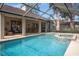 Inviting screened pool and spa with patio seating at 16809 Woburn Ln, Lutz, FL 33549