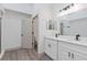 Modern bathroom with double vanity and white cabinets at 1946 Hammocks Ave, Lutz, FL 33549