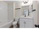 Clean bathroom with a single vanity and shower/tub combo at 1946 Hammocks Ave # 803, Lutz, FL 33549