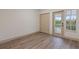 Spacious bedroom with wood-look floors and private balcony access at 1946 Hammocks Ave # 803, Lutz, FL 33549