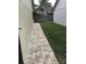 Brick walkway leads to a grassy backyard at 2217 Sequoia Dr, Clearwater, FL 33763