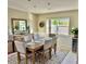 Formal dining room featuring wainscoting, a large table with seating, and a stylish rug at 2217 Sequoia Dr, Clearwater, FL 33763