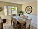 Dining room with a large wooden table, six chairs, and a decorative clock at 2217 Sequoia Dr, Clearwater, FL 33763