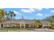 A view of the building's front exterior elevation featuring a flag pole, wreath and tropical landscaping at 2217 Sequoia Dr, Clearwater, FL 33763