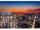 Aerial view of modern highrise building at sunset with city skyline in background at 235 1St S Ave # 1106, St Petersburg, FL 33701