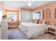 Cozy bedroom with coral walls, white bed and built-in desk at 2670 Sequoia Ter # 1406, Palm Harbor, FL 34683