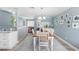 Dining room with wooden table, white chairs, and a home office at 2670 Sequoia Ter # 1406, Palm Harbor, FL 34683