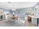 Bright dining room with white table and chairs, home office area at 2670 Sequoia Ter # 1406, Palm Harbor, FL 34683