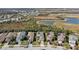 Aerial view of neighborhood with pond and homes at 2721 Tarragona Way, Wesley Chapel, FL 33543