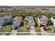 Aerial view of homes with solar panels and a pond at 2721 Tarragona Way, Wesley Chapel, FL 33543