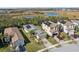 Aerial view of homes with solar panels and a pond at 2721 Tarragona Way, Wesley Chapel, FL 33543