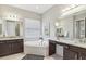 Elegant bathroom with double vanity and corner soaking tub at 2721 Tarragona Way, Wesley Chapel, FL 33543