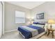 Bedroom with a double bed, nightstands, and blue bedding at 2721 Tarragona Way, Wesley Chapel, FL 33543