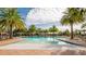 Resort-style pool with palm trees and lounge chairs at 2721 Tarragona Way, Wesley Chapel, FL 33543