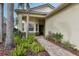 Brick walkway leads to front entrance with lush landscaping at 2721 Tarragona Way, Wesley Chapel, FL 33543