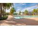 Relaxing pool area with lounge chairs and palm trees at 2721 Tarragona Way, Wesley Chapel, FL 33543