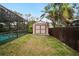 Storage shed in backyard near pool and fence at 3006 Mockingbird Ct, Clearwater, FL 33762