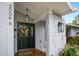 Inviting entryway with a black front door and stone pillars at 3006 Mockingbird Ct, Clearwater, FL 33762