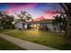 Beautiful home exterior at dusk with landscaping and a well-maintained lawn at 3006 Mockingbird Ct, Clearwater, FL 33762