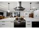 Modern kitchen with a stainless steel range hood and expansive island at 3006 Mockingbird Ct, Clearwater, FL 33762