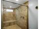 Large walk-in shower with tiled walls and built-in seat at 3006 Mockingbird Ct, Clearwater, FL 33762