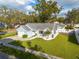 Blue house with a well-maintained lawn, viewed from above at 3102 Jarvis St, Holiday, FL 34690